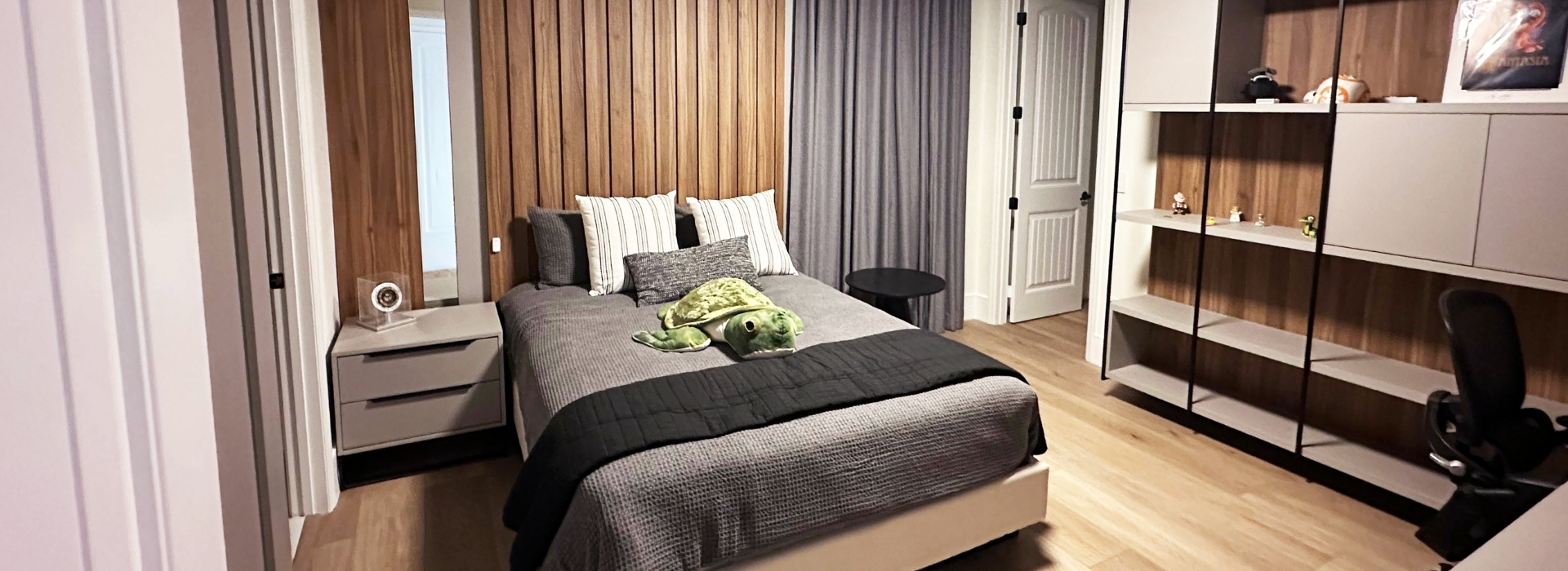 Modern Bedroom with Wood Accent Wall and Built-in Storage